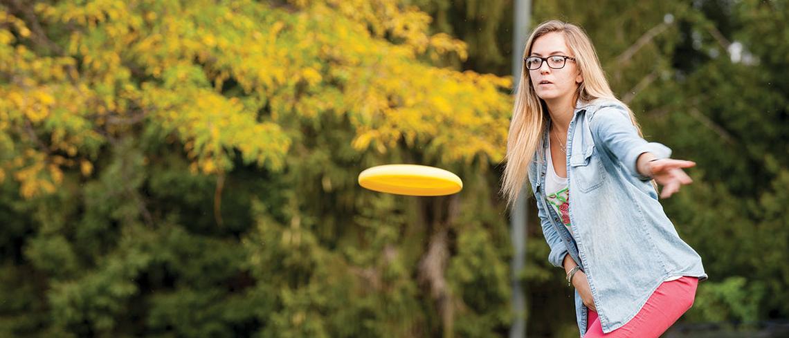 Student throwing frisbee